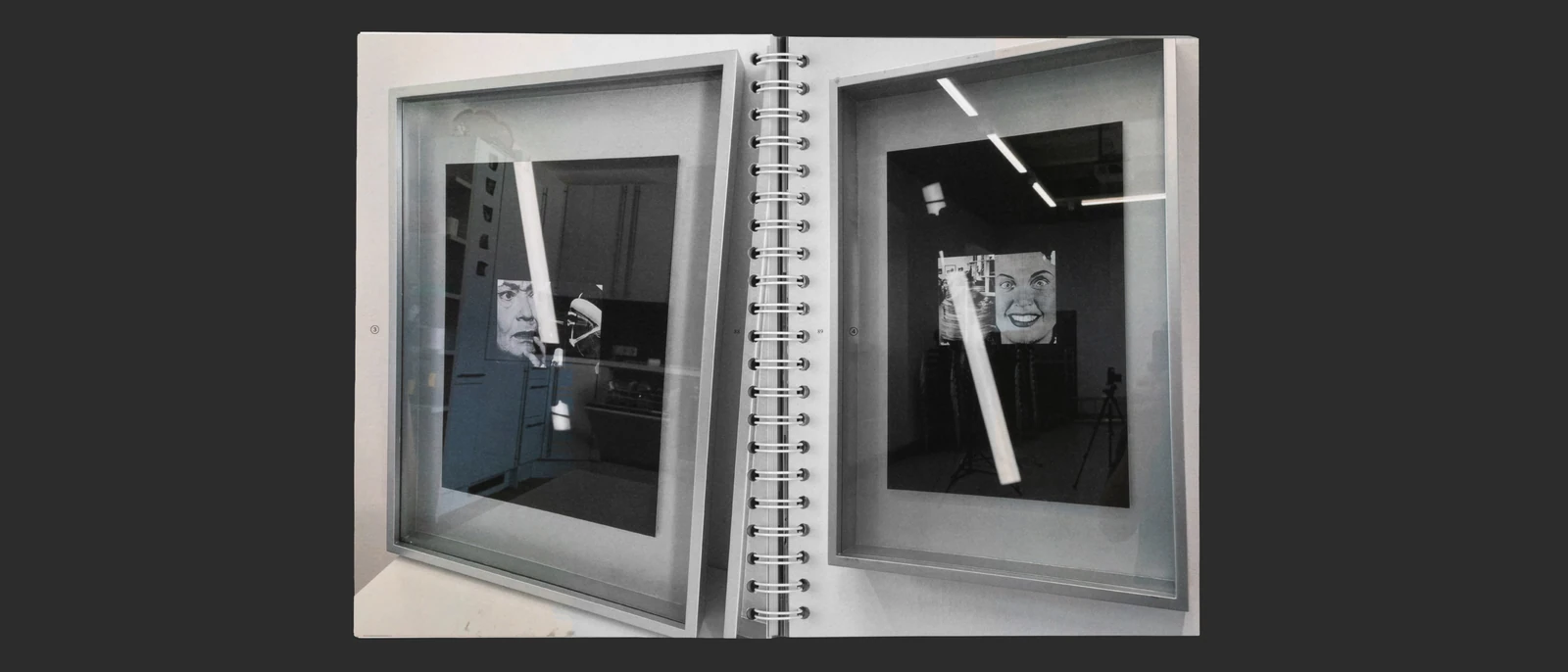 Open thesis spread with photographs of framed black-and-white works.