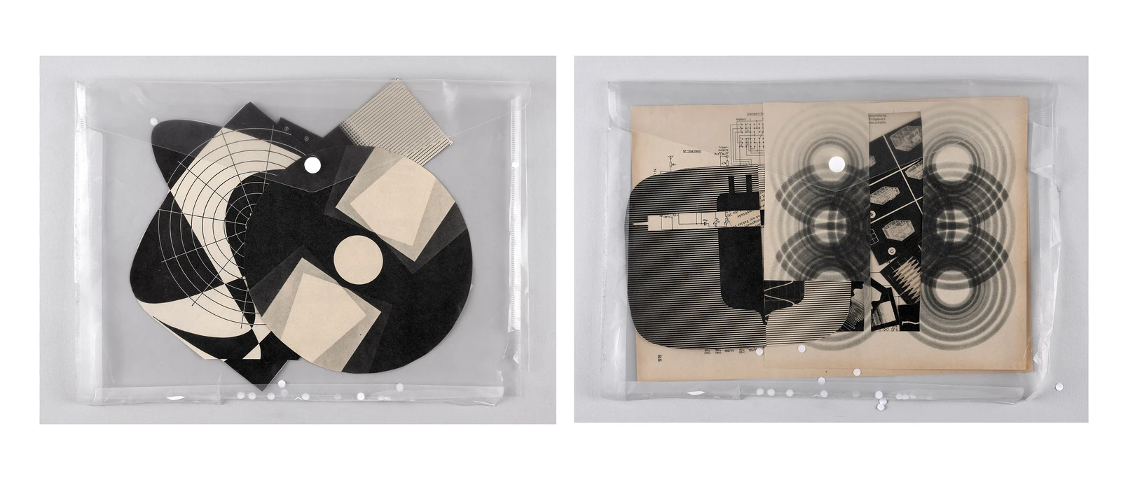 Black-and-white geometric cut-outs arranged inside a transparent tray.